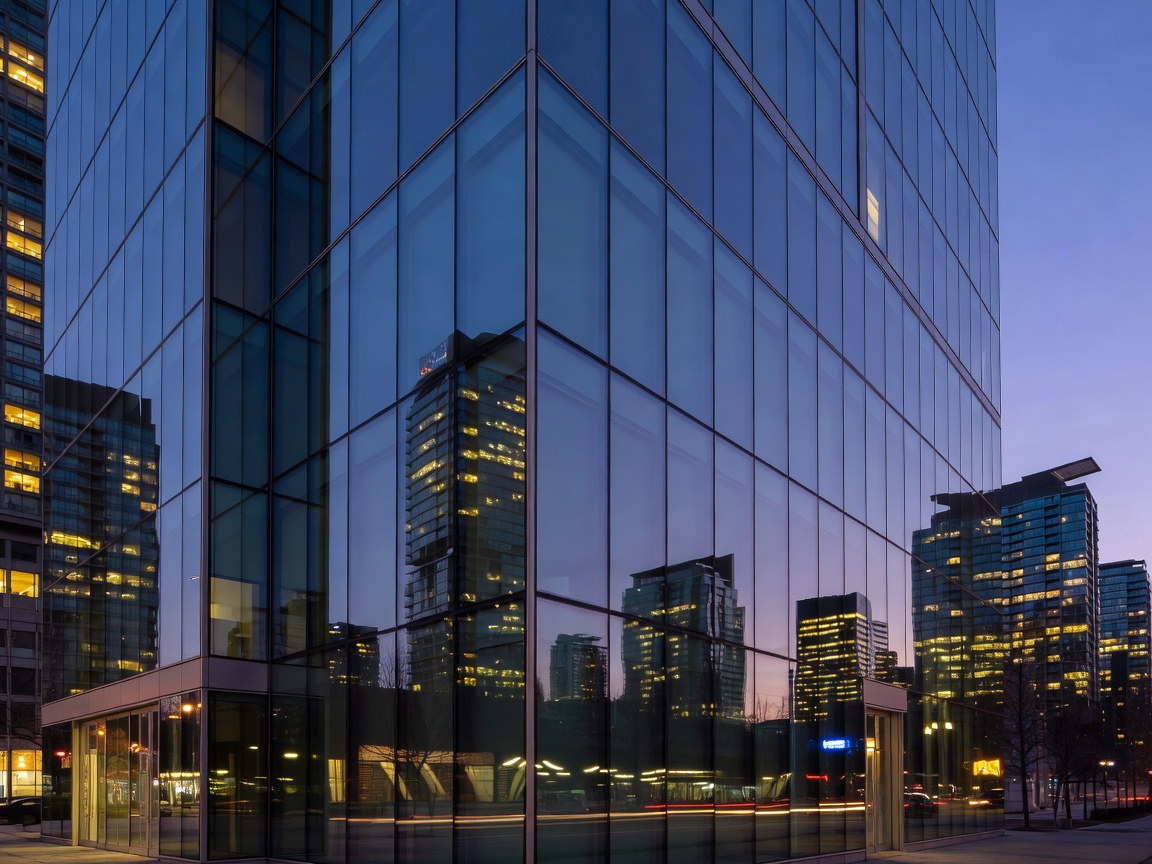 The modern glass facade of Parq Vancouver reflecting the city light